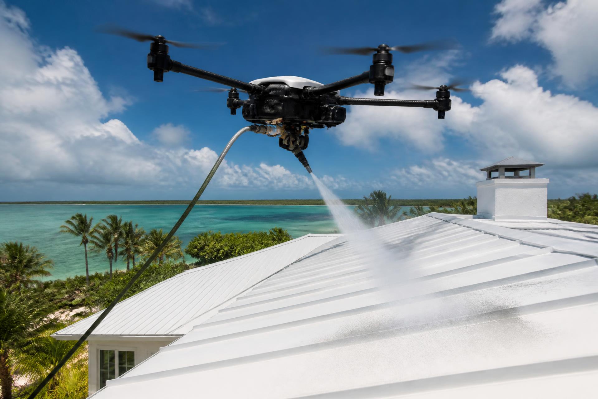 Drone pressure washing a white metal roof above turquoise Bahamian water